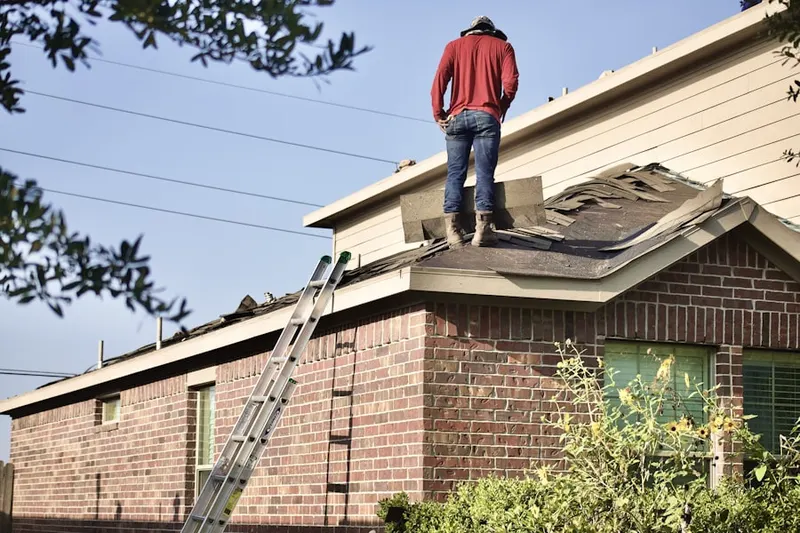 Professional roofer working on a residential roof in Hollow Woods